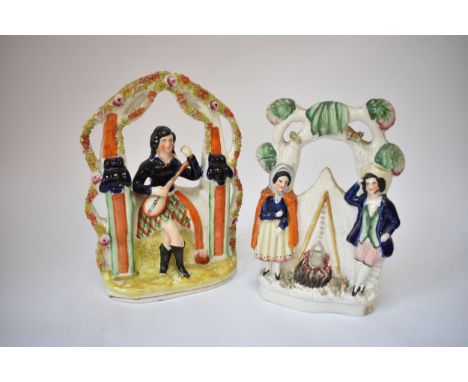 Two Staffordshire arbour figures.  Figures by camp fire and seated musicians, crack to neck and chip to base of first example