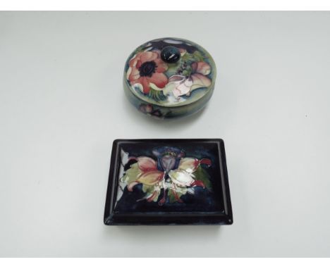 A Moorcroft "Freesia" pattern lidded rectangular trinket pot, marked to base, 12cm long, together with another Moorcroft trin