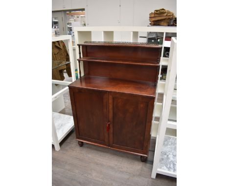 In the manner of Gillows of Lancaster, a circa 1820 Regency flame mahogany chiffonier, the raised two tier shelved back on tu