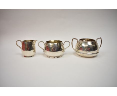 A Victorian Charles Edward silver twin handled sugar bowl and cream jug, London 1877, and a further silver sugar bowl by Bark
