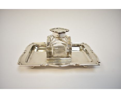 A Stokes &amp; Ireland Ltd silver desk tidy, the shaped rectangular tray set with central silver topped crystal glass inkwell