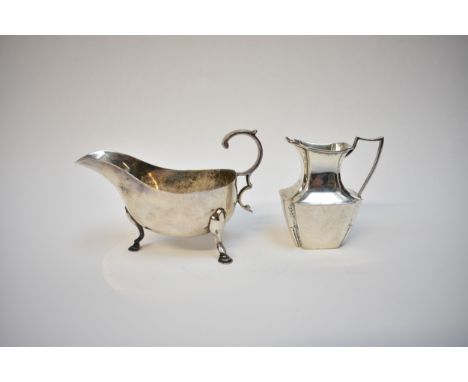 A Martin Hall &amp; Co silver sauce boat, Sheffield 1906, 14cm long and William Hutton &amp; Son silver cream jug, London 189
