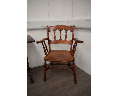 A circa 1830 "East Anglian" elm and fruitwood armchair the shaped bar backrest with turned supports having end broad arms on 