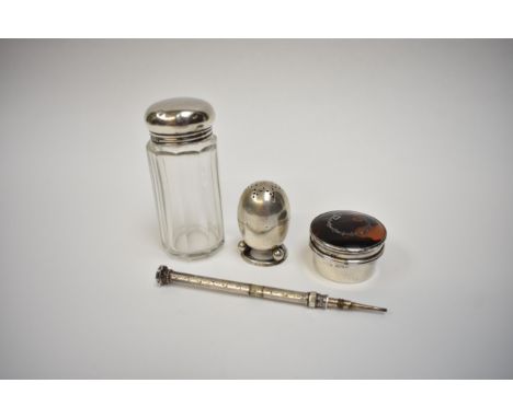 A silver egg form pepperette with star pierced top, London 1893, an Edwin Joseph Houlsten silver pill pot with tortoiseshell 