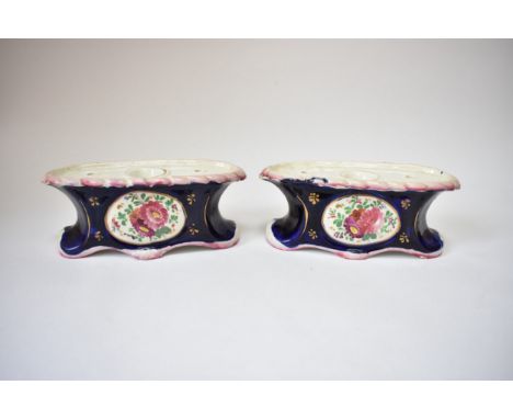 A pair of mid 19th Century Staffordshire desk inkwell pedestals with quill holders, floral decoration.  7cm x 18cm