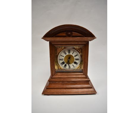 A Junghans bracket clock striking on a coiled gong in light oak architectural form case, 32cm tall x 26cm wide