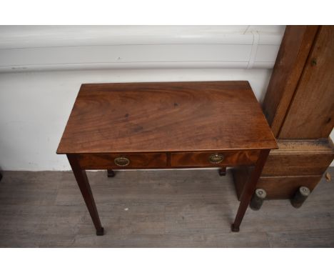 A George III flame mahogany side table with satinwood line inlay, the two frieze drawers over square tapering legs, 72.5cm x 