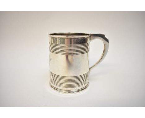 A George III silver pint tankard with central bearded gentleman bust crest surrounded by a wheat ear wreath.  The main body w