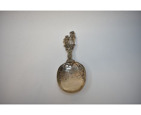 A Berthold Muller highly ornate silver figural spoon with musicians playing the bagpipes and violin.  The bowl decorated with