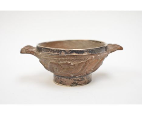 A Ferguson and Macbean of Inverness oak miniature quaich, the body carved with snakes and mammal, the interior with silver di