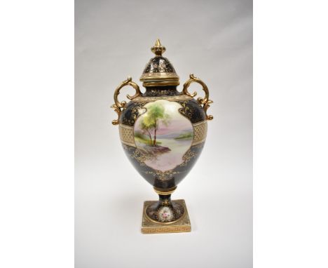A 20th Century Noritake porcelain urn with cover. The twin handled urn having two central landscape cartouches, raised on flo