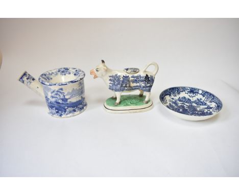 An early 19th Century Staffordshire spittoon with transfer-print scene, base marked.  A cow creamer, horn missing and Worcest
