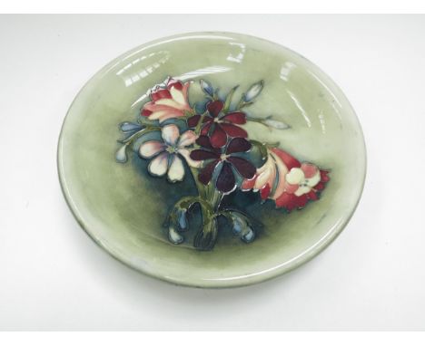 A Moorcroft "Columbine" pattern dish, signed to base, 22cm diameter