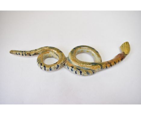 A circa 1820 Prattware tobacco pipe in the shape of a coiled sinuous snake, damage and repair present to centre.  31cm long