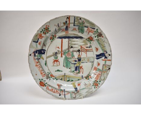 An 18th Century Chinese charger, the outer border decorated with four figural cartouches in different pursuits, the central i