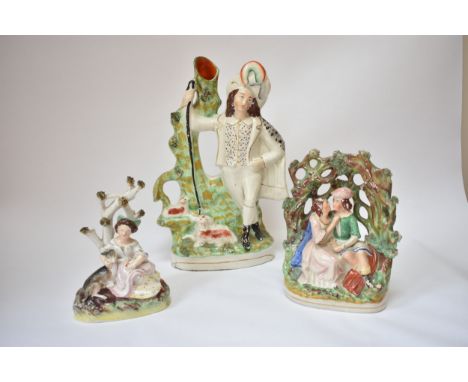 Three Victorian Staffordshire figures including couple seated under an arbour, girl by tree and shepherd spill vase, hairline