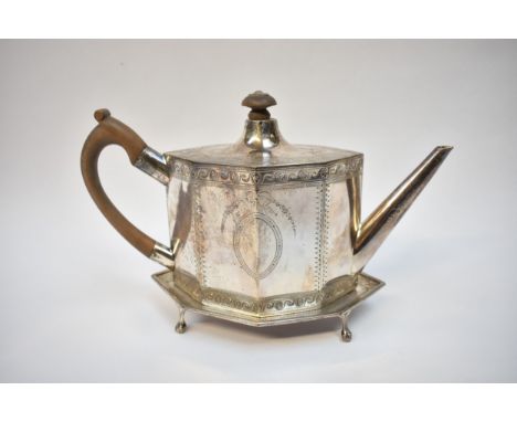 A John Denzilow George III silver teapot and stand of facet lozenge form with treen handle and knop.  The lid has a dragon's 
