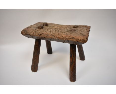 An early rustic elm stool, 21cm tall x 29.5cm x 19cm