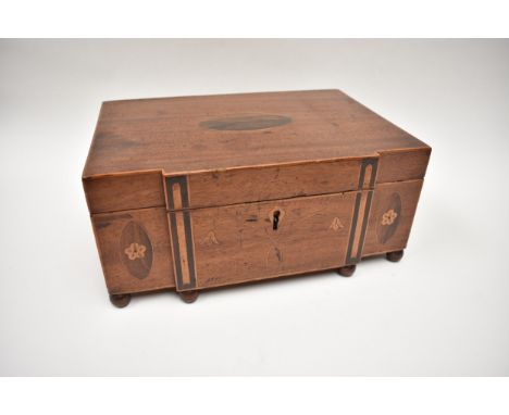 A Georgian mahogany breakfront jewellery box with floral inlaid motifs, raised on six ball feet, rustic interior, 13cm x 29cm