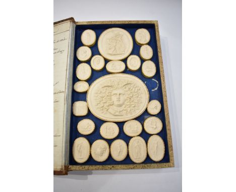 A collection of Grand Tour intaglios, housed within original book-form case, with handwritten index to inner cover