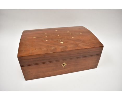 A 20th Century hardwood domed top jewellery box, inlaid with brass.  The top opens to reveal a compartmented removable tray, 