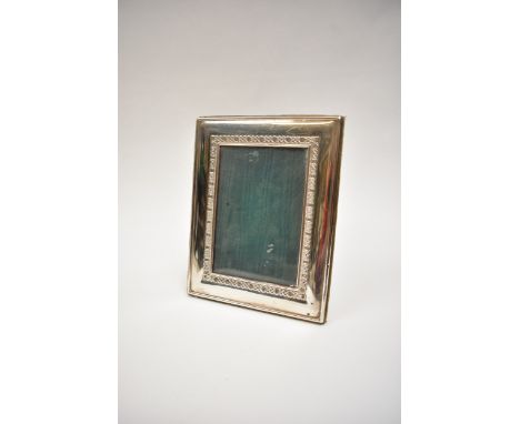 A Carrs of Sheffield silver photograph frame with Celtic knot border, date letter for 2001.  Frame 18cm x 14.3cm, aperture 12