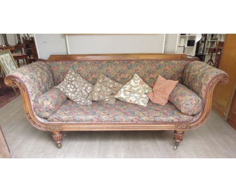 A William IV rosewood scroll arm sofa with floral upholstery, melon fluted legs, with scatter cushions, 96cm x 210cm x 69cm