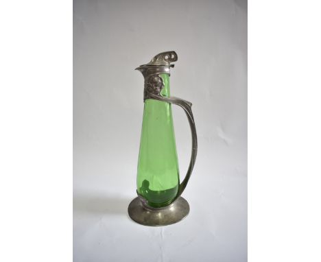 A Liberty and Co Tudric patinated pewter and green glass flagon on claret jug un the style of Archibald Knox No.0264. Attribu