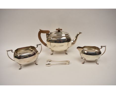 A Sheffield silver three piece teaset with date letter for 1928, treen handle and knop, marks rubbed with an associated pair 