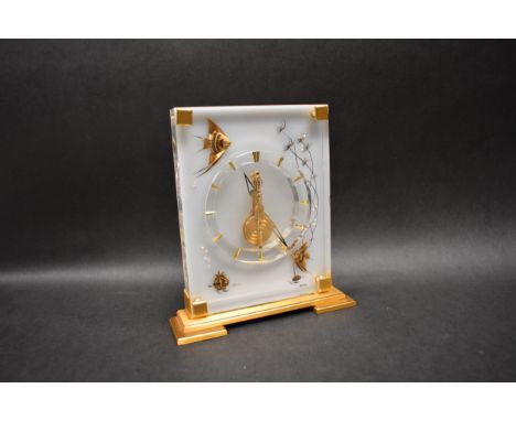 A Jaeger-LeCoultre "Marina" pattern desk clock.  Mechanism needs work as loose cog present to front.  Scuffing to Perspex.  2