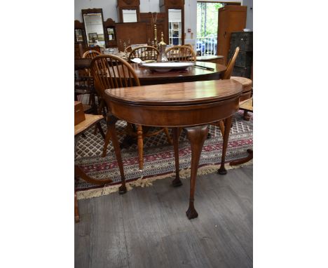 A mahogany demi-lune card table with green baize slender tapering legs, 74.5cm tall x 84cm x 41cm closed