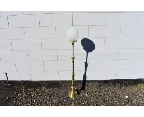 A polished brass standard lamp with opaque fluted globe shade, 29cm tall