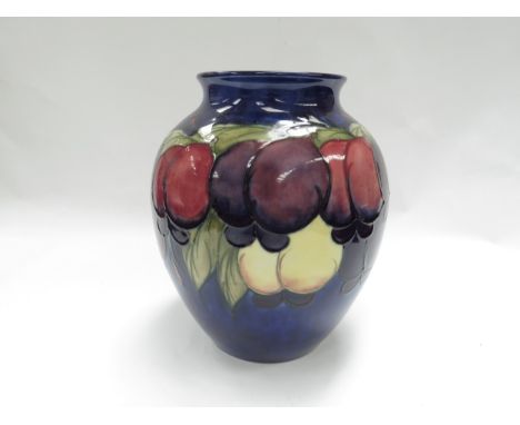 A Moorcroft Wisteria Plum pattern vase on blue ground, 21cm tall