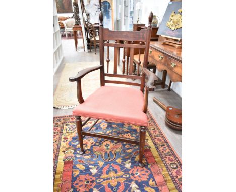 A late 19th/early 20th Century Arts &amp; Crafts armchair with ball and finial detail, red seat, pad feet, 111cm tall x 62cm 