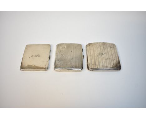 Three silver cigarette cases of varying designs, all monogrammed, two engine-turned.  Two have inscriptions to the interior, 