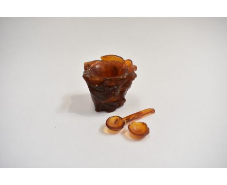 A Chinese carved amber salt, carved in relief with bird amongst foliage, 3.5cm x 4cm, 26g