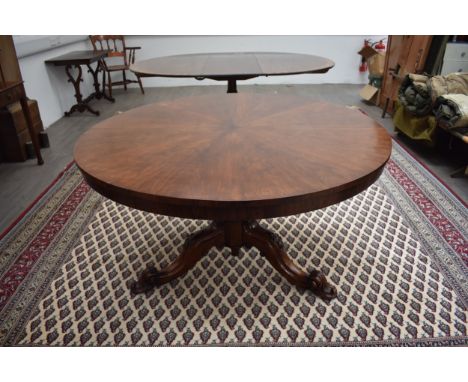 A William IV rosewood circular tilt-top table the chamfered bulbous column and carved acorn/oak leaf tripod base with leaf sc