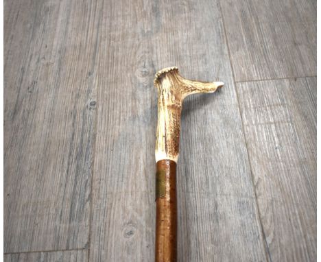 A hazelwood walking staff with deer antler whistle crown handle and "National Trust Ixworth" brass plaque, 136cm long