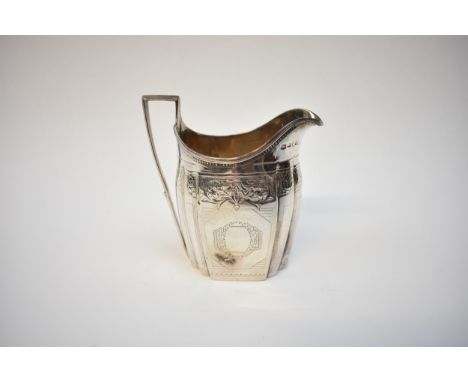 A George III Thomas Wallis II silver milk jug, London 1796, with monogrammed cartouche, floral engraving/decoration, approxim