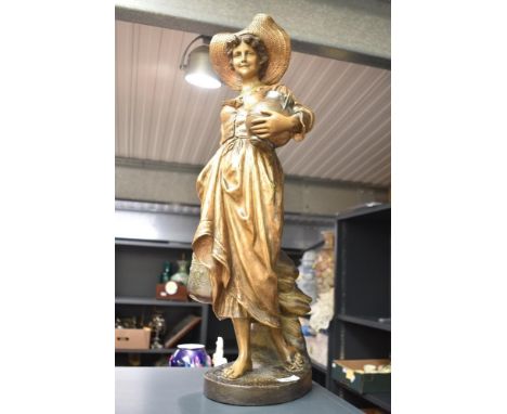 A Goldscheider figure of a Dutch girl carrying a water jug, h66cm