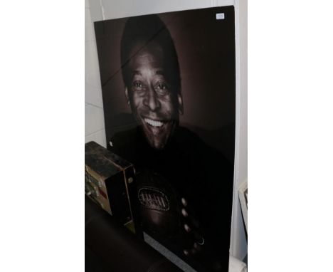 A large photographic print of Pele and a group of FIFA posters