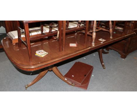 Mahogany crossbanded twin-pedestal dining table in the Regency style, with one additional leaf .  Fully extended 77cm H, 256c