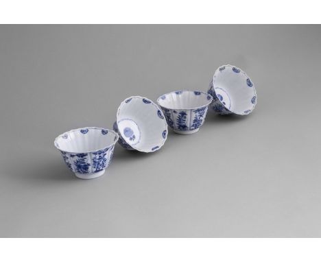 A SET OF FOUR FLARED BLUE AND WHITE CUPS, 19th century, of tapering design, each with wavy rims, painted with foliate groups 