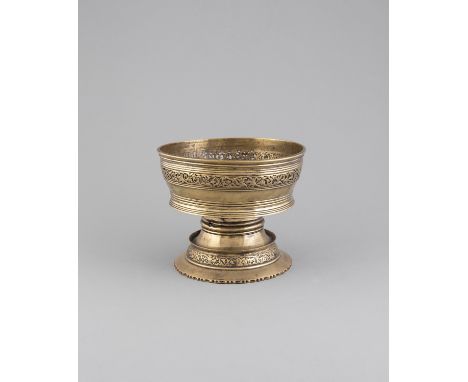 A TIBETAN BUTTER LAMP, 18/19th Century with broad bowl pierced with a band of leafy scrolls, on a waisted stem and spreading 