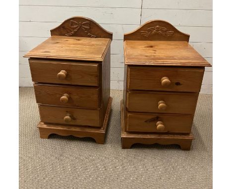 A pair of pine bedsides with drawers and carved ribbon bow details to back (H71cm W42cm D37cm)