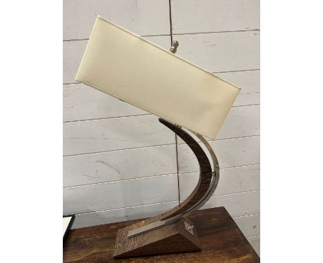 A table lamp with curving stand with chrome details 