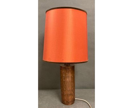 A table lamp with a copper base 