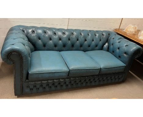 An aqua Chesterfield sofa with stud details to arms 