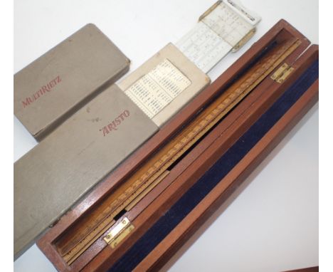 Cased set of wooden architectural rules and a cased slide rule