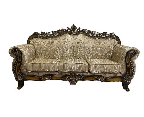 Italian Baroque design three seat sofa, hardwood framed, the cresting rail carved and pierced with c-scrolls and flower heads